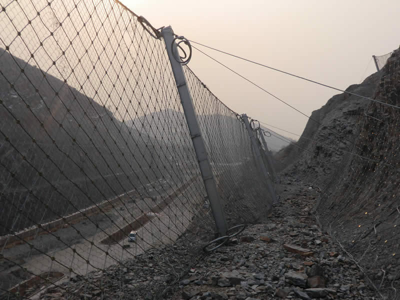 RX rockfall barrier system installed between road and steep rock slope