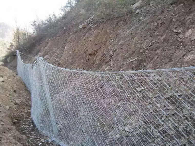 Close view of RX passive rockfall barrier system capturing rockfall