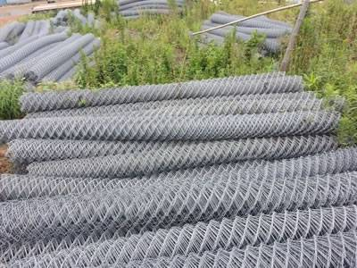 Several rolls of tecco mesh on the grassland.